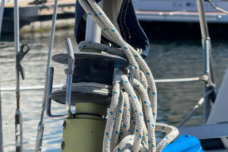 Close-up of a 1988 Gulf Pilot House sailboat rigging with coiled ropes.
