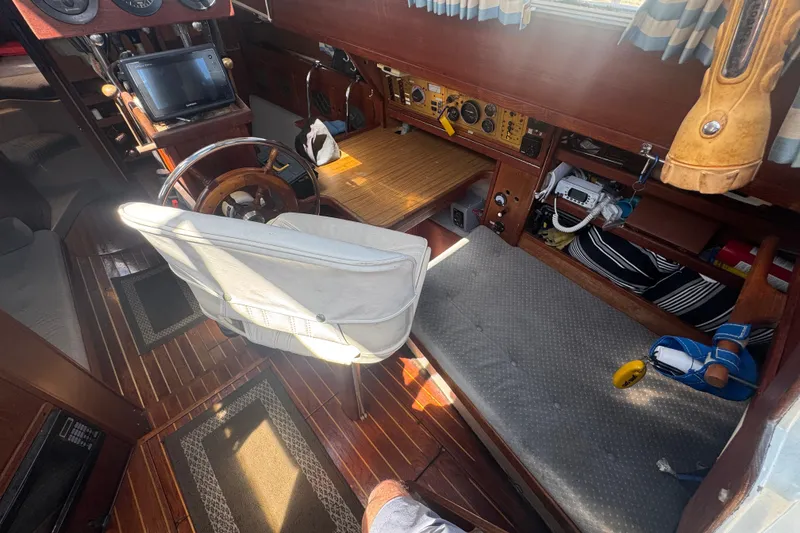 Interior of a 1988 Gulf Pilot House boat with wooden accents and navigation equipment.