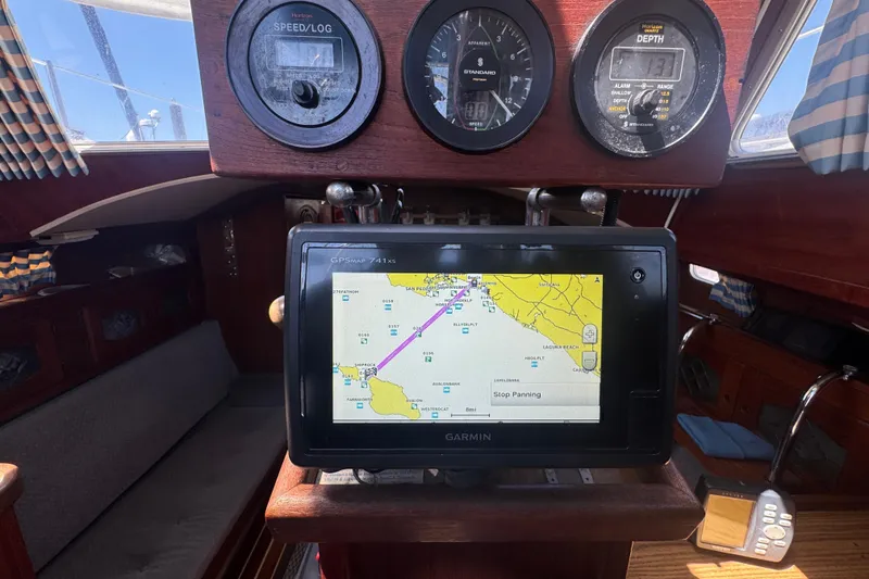 1988 Gulf Pilot House interior with navigation instruments and GPS display.