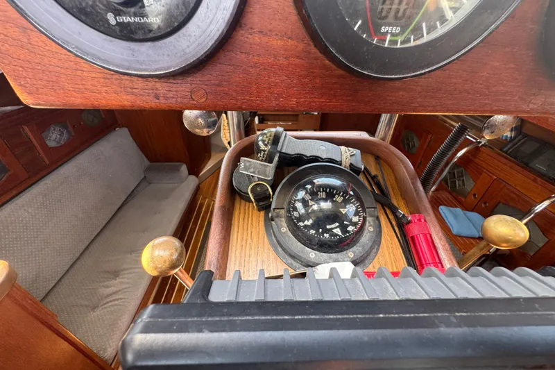 Interior of a 1988 Gulf Pilot House boat with compass and speedometer.