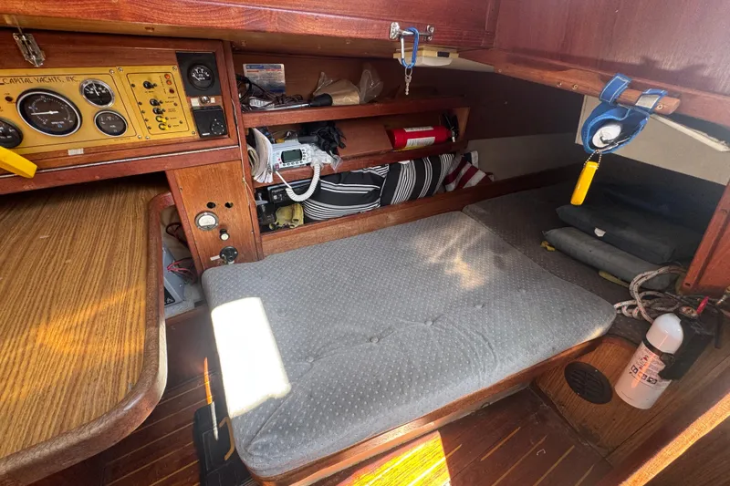 Cozy cabin interior of a 1988 Gulf Pilot House boat with navigation equipment and storage.