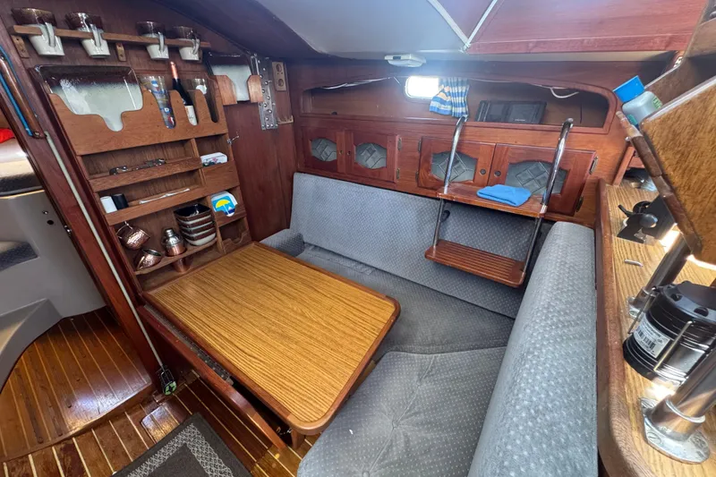 Cozy 1988 Gulf Pilot House interior with wooden furnishings and seating area.