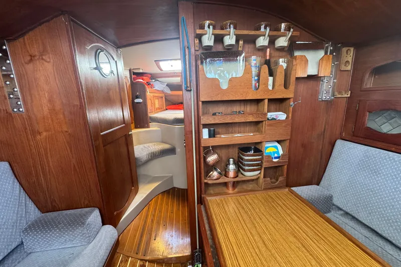 Interior of a 1988 Gulf Pilot House boat with wooden cabinetry and seating area.