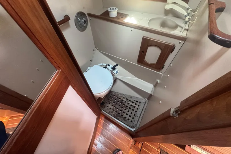 1988 Gulf Pilot House bathroom with wooden accents and compact design.