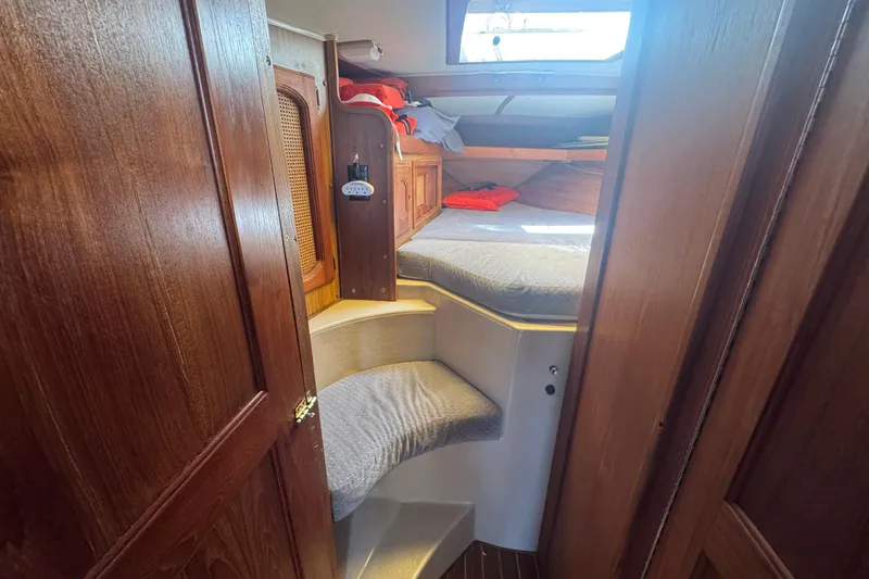 1988 Gulf Pilot House interior with wooden finish and cozy sleeping area.