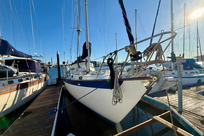 1981 Mariner Mayflower sailboat docked at marina under clear blue sky.