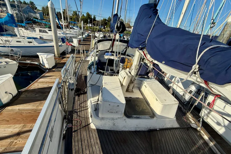 1981 Mariner Mayflower sailboat docked at marina, featuring deck and rigging.