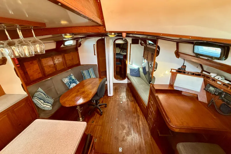 Interior of 1981 Mariner Mayflower yacht with wooden furnishings and cozy seating area.