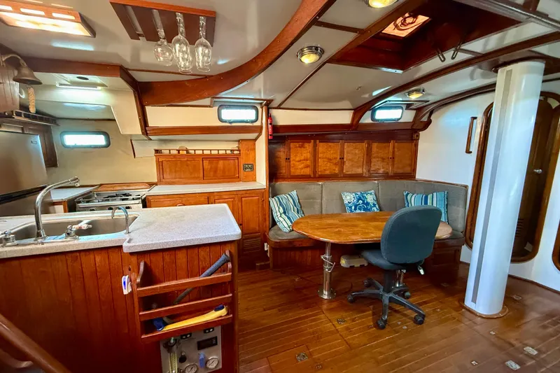 Interior of 1981 Mariner Mayflower yacht with wooden furnishings and cozy seating area.