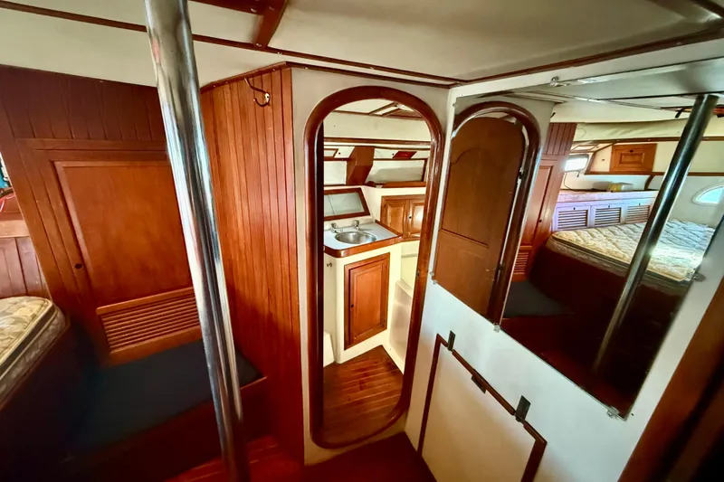 Interior of 1981 Mariner Mayflower yacht with wood paneling and compact kitchen area.