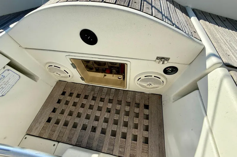 Cockpit area of 1988 Beneteau Oceanis 390 sailboat with wooden flooring and speaker system.
