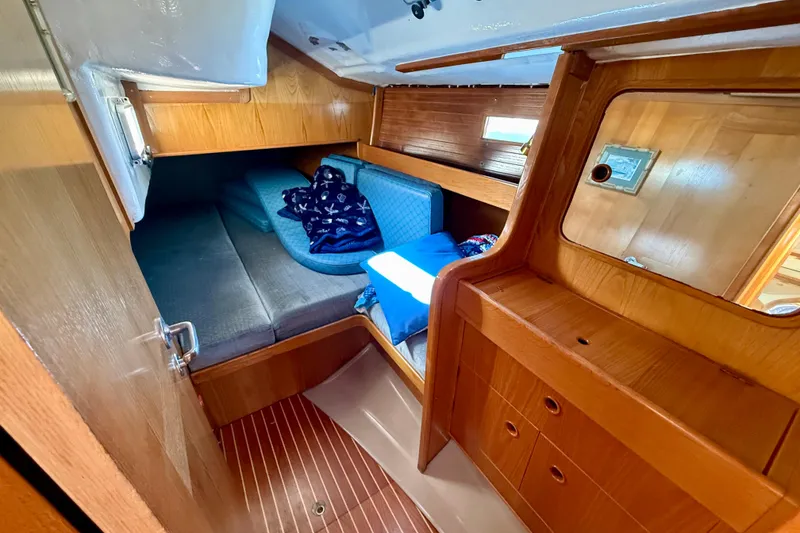 Cozy cabin interior of 1988 Beneteau Oceanis 390 sailboat with wooden furnishings.