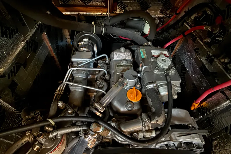 Engine compartment of a 1988 Beneteau Oceanis 390 sailboat, showcasing detailed mechanical components.