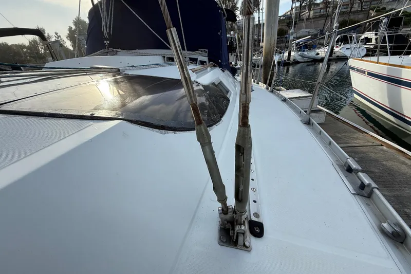 1988 Beneteau Oceanis 390 sailboat deck view in marina, showcasing rigging and sleek design.