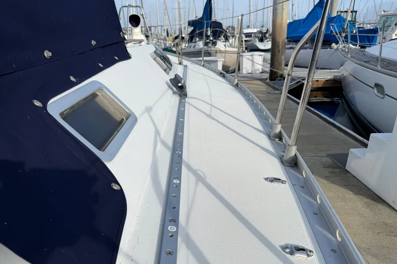 1988 Beneteau Oceanis 390 sailboat deck view at marina, showcasing sleek design and craftsmanship.