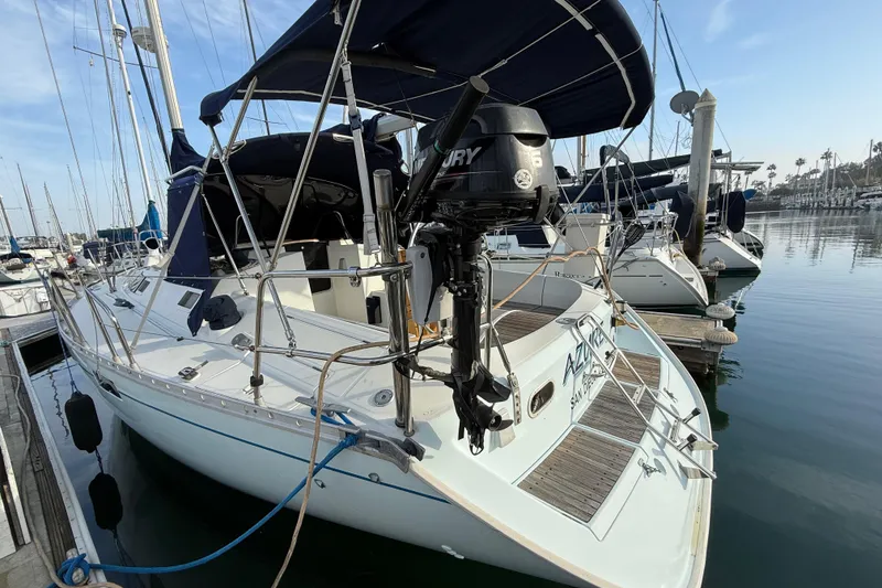 1988 Beneteau Oceanis 390 sailboat docked in marina, featuring Mercury outboard motor.