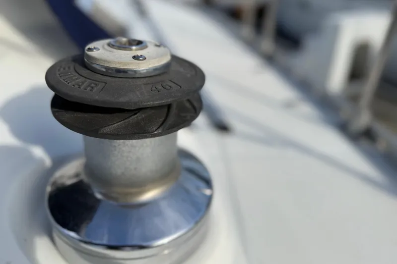 Close-up of a winch on a 1988 Beneteau Oceanis 390 sailboat deck.