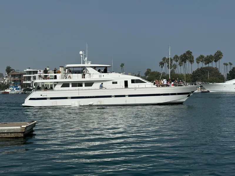 Versilcraft Challenger Motor Yacht 1990 cruising on a calm waterway with palm trees in the background.