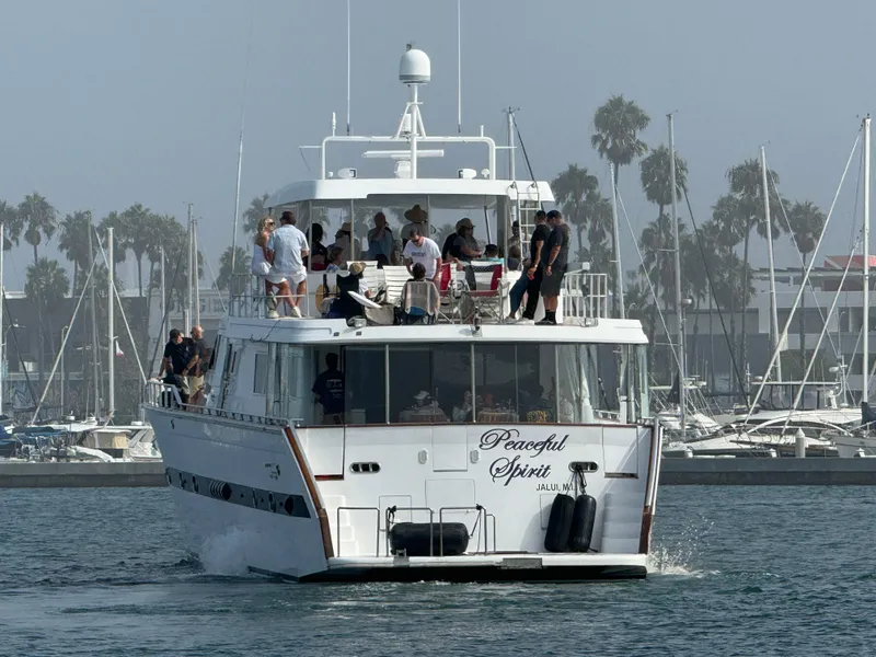 Versilcraft Challenger Motor Yacht 1990, "Peaceful Spirit," cruising with passengers in a marina.