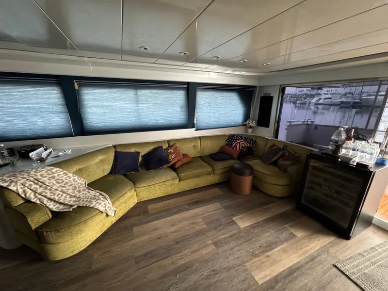 Luxurious interior of 1990 Versilcraft Challenger Motor Yacht with cozy seating and scenic window view.
