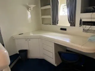 1990 Versilcraft Challenger Motor Yacht interior with desk, shelves, and window.