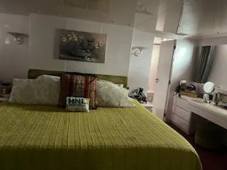 Luxurious bedroom interior of 1990 Versilcraft Challenger Motor Yacht with elegant decor.