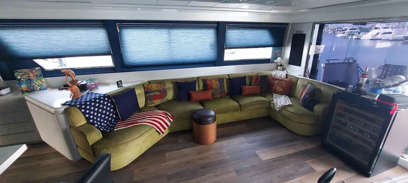 Luxurious 1990 Versilcraft Challenger yacht interior with plush seating and vibrant decor.