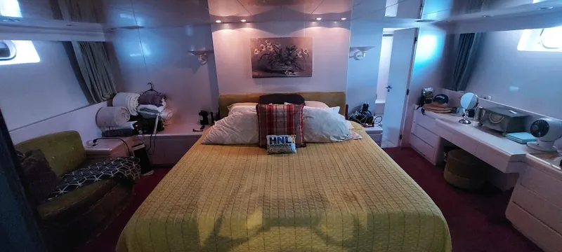 Luxurious bedroom interior of 1990 Versilcraft Challenger Motor Yacht with elegant decor and cozy ambiance.