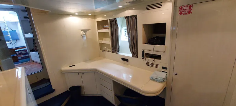 Interior of 1990 Versilcraft Challenger Motor Yacht with desk and shelving.