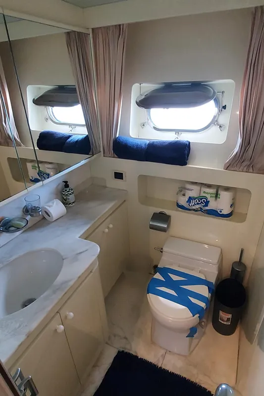 1990 Versilcraft Challenger Motor Yacht bathroom with sink, toilet, and window.