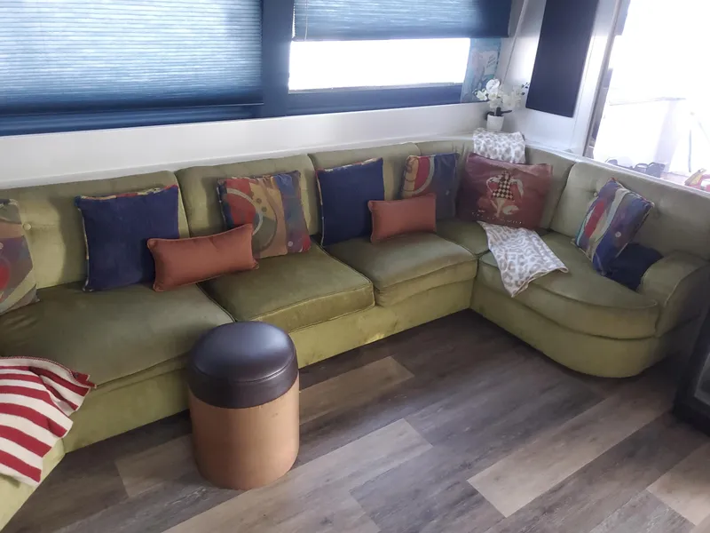Luxurious interior of 1990 Versilcraft Challenger Motor Yacht with plush seating and decorative cushions.