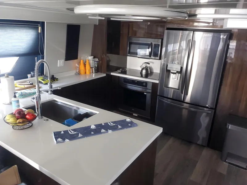 Modern kitchen interior of 1990 Versilcraft Challenger Motor Yacht with stainless steel appliances.