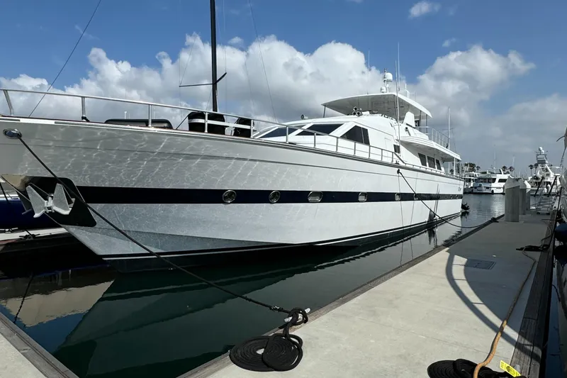 1990 Versilcraft Challenger Motor Yacht docked at marina under blue sky.
