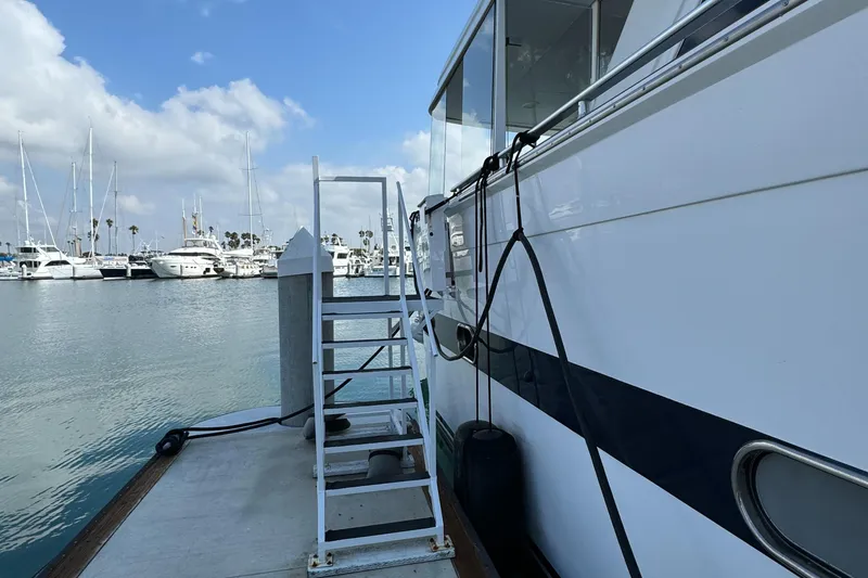 Versilcraft Challenger Motor Yacht 1990 docked at marina with boarding ladder.