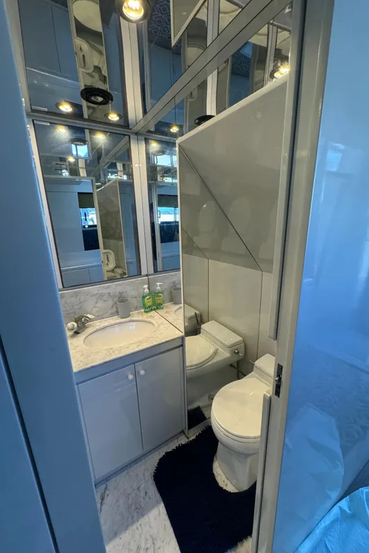 Luxurious bathroom in 1990 Versilcraft Challenger Motor Yacht with modern fixtures and mirrored walls.
