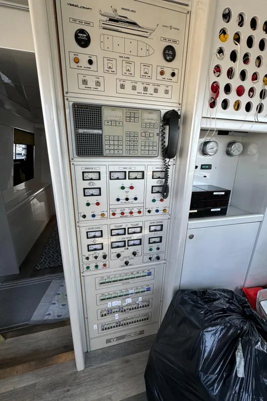 Control panel inside 1990 Versilcraft Challenger Motor Yacht, featuring various switches and gauges.