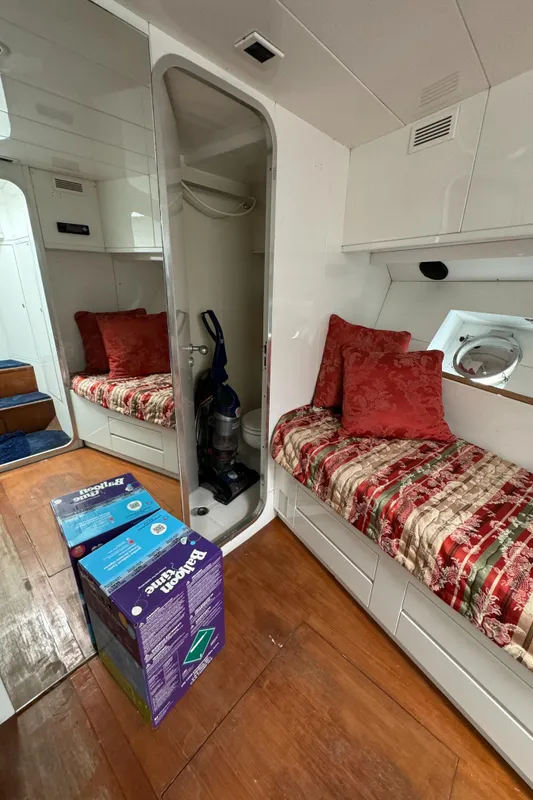 Interior of 1990 Versilcraft Challenger Motor Yacht with cozy seating and wooden flooring.