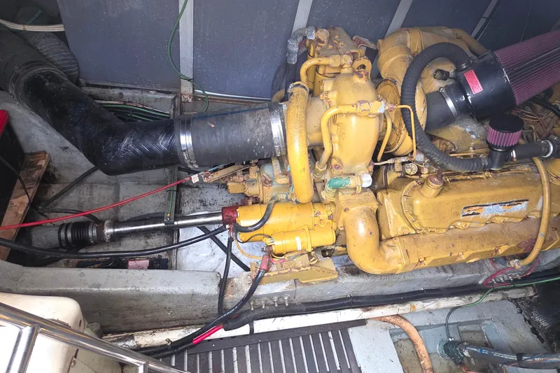 Engine compartment of a 1988 Sea Ray 460 Express Cruiser, showcasing a yellow marine engine.