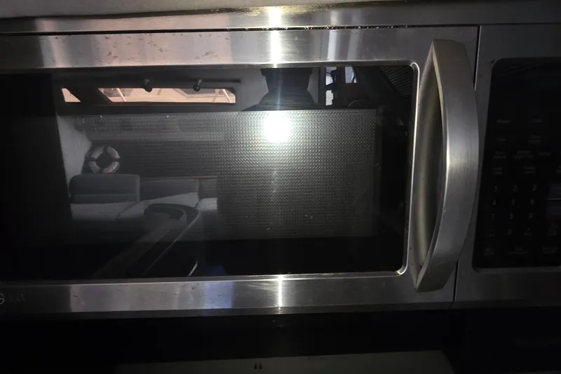 Microwave oven inside 1988 Sea Ray 460 Express Cruiser yacht kitchen.