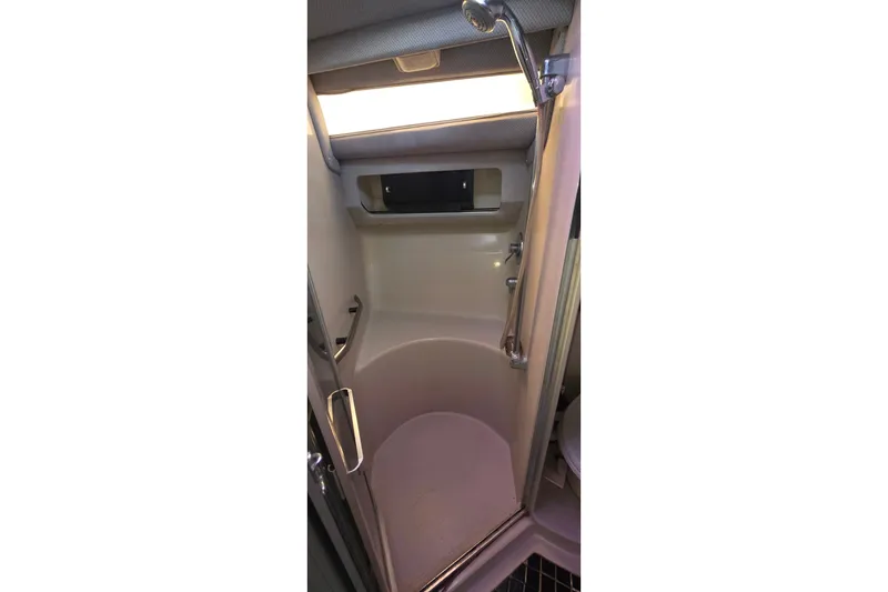 Shower area inside 1988 Sea Ray 460 Express Cruiser, featuring compact design and modern fixtures.