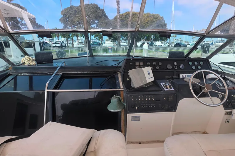Cockpit of 1988 Sea Ray 460 Express Cruiser with steering wheel and control panel.