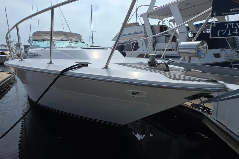 1988 Sea Ray 460 Express Cruiser docked at marina, showcasing sleek design and spacious deck.