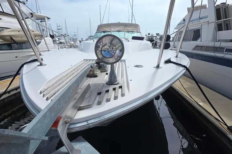 1988 Sea Ray 460 Express Cruiser docked, showcasing sleek design and nautical equipment.