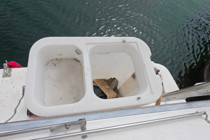 1988 Sea Ray 460 Express Cruiser swim platform with storage compartments above water.