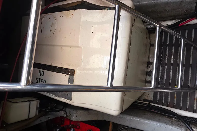 1988 Sea Ray 460 Express Cruiser engine compartment with metal railing and equipment.