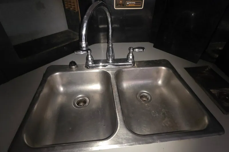 Stainless steel double sink in 1988 Sea Ray 460 Express Cruiser kitchen.