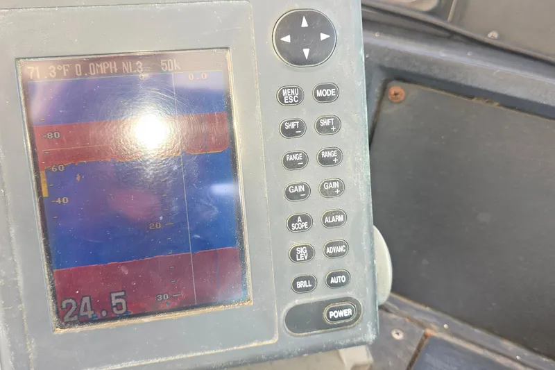 Control panel of a 1988 Sea Ray 460 Express Cruiser displaying temperature and speed.
