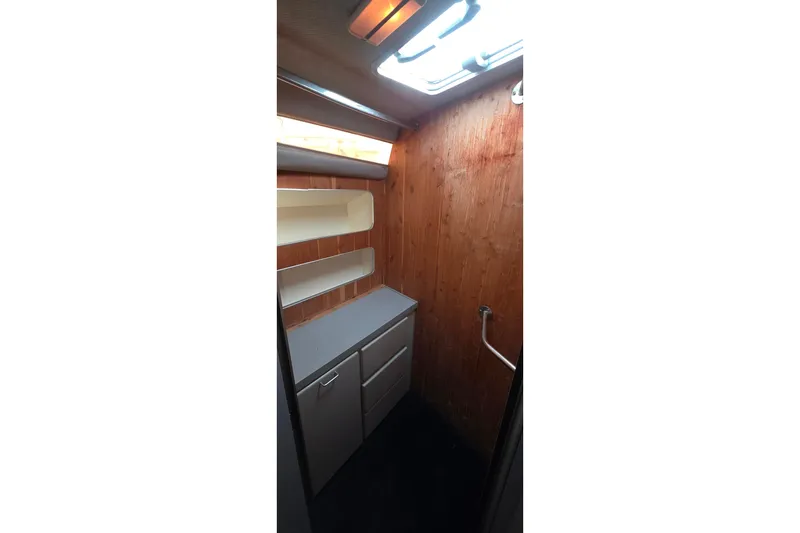 Interior of 1988 Sea Ray 460 Express Cruiser with wooden walls and storage cabinets.