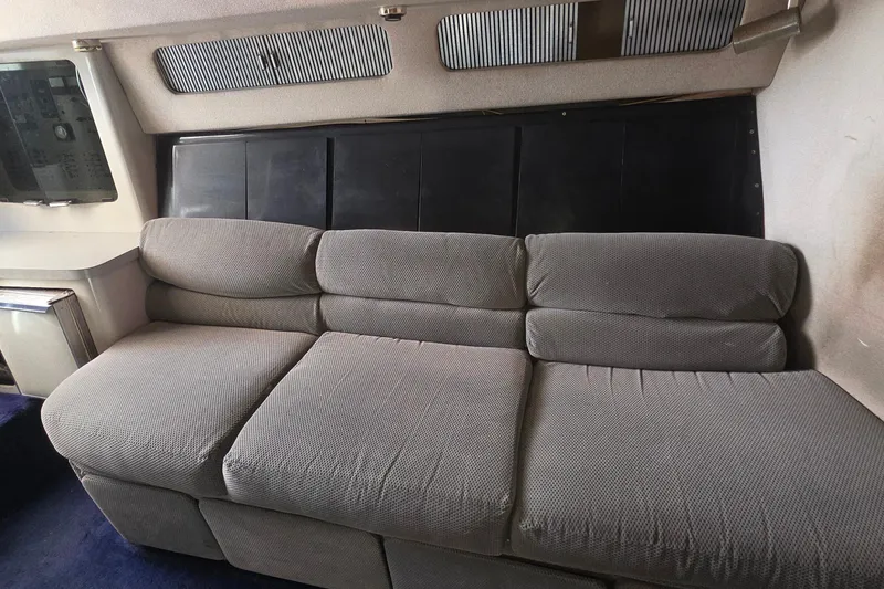 Interior of 1988 Sea Ray 460 Express Cruiser with gray upholstered seating.