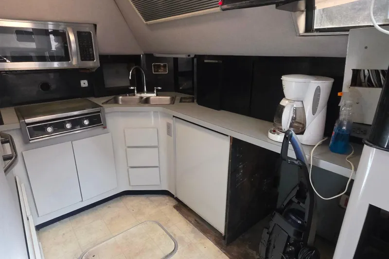 1988 Sea Ray 460 Express Cruiser kitchen with appliances and modern fixtures.